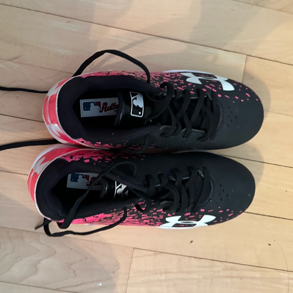 Youth size one pink and black soccer cleats